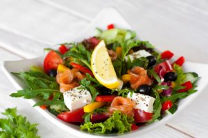 Salmon salad traditional serving on wood